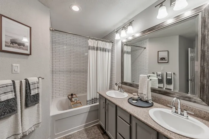 Bathroom with double vanity and high end finishes at Alister Galleria apartments houston texas