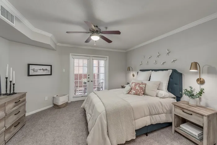 Large bedroom with fan and plush carpeting at Alister Galleria apartments houston texas