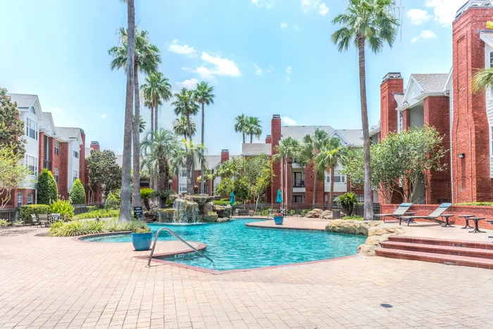 Outdoor pool area with lounge seating at Alister Galleria apartments in houston texas