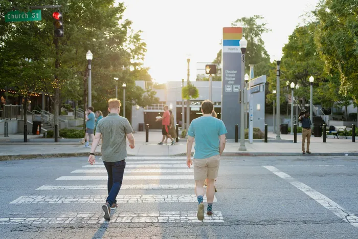people using crosswalk near modera decatur apartments georgia neighborhood retail