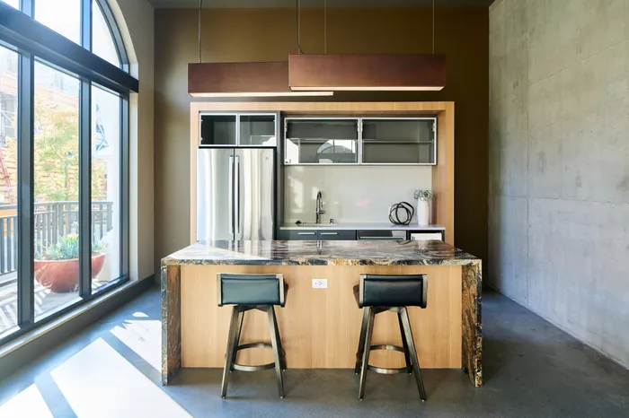 island with seating and prep kitchen at Modera Berkeley apartments California