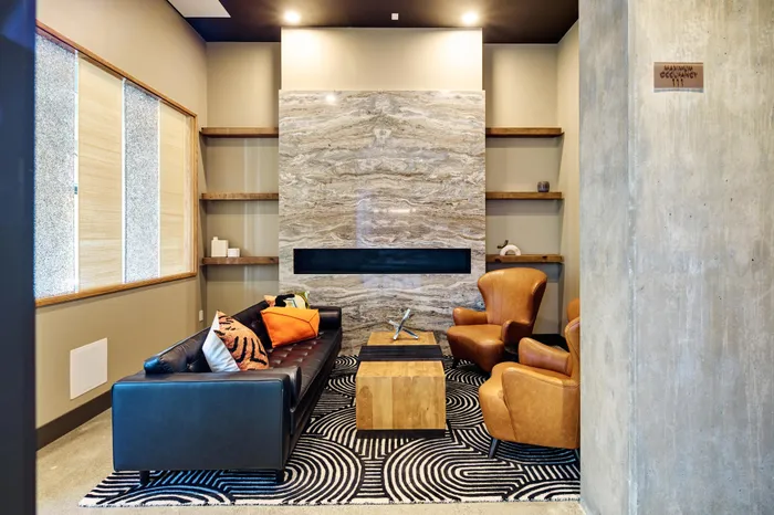 resident lounge area with stylish seating and fireplace at Modera Berkeley apartments California