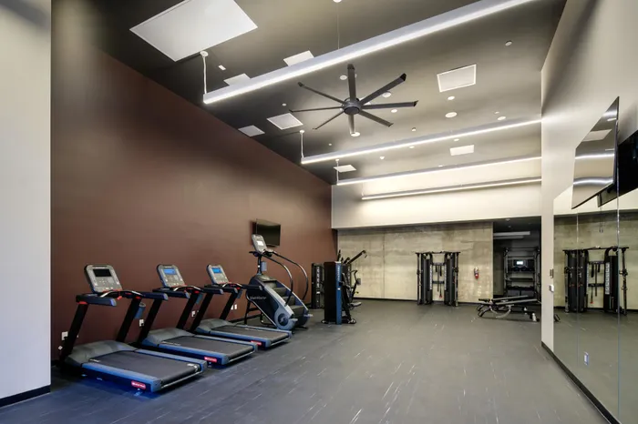 large fitness center with high-end equipment at Modera Berkeley apartments California