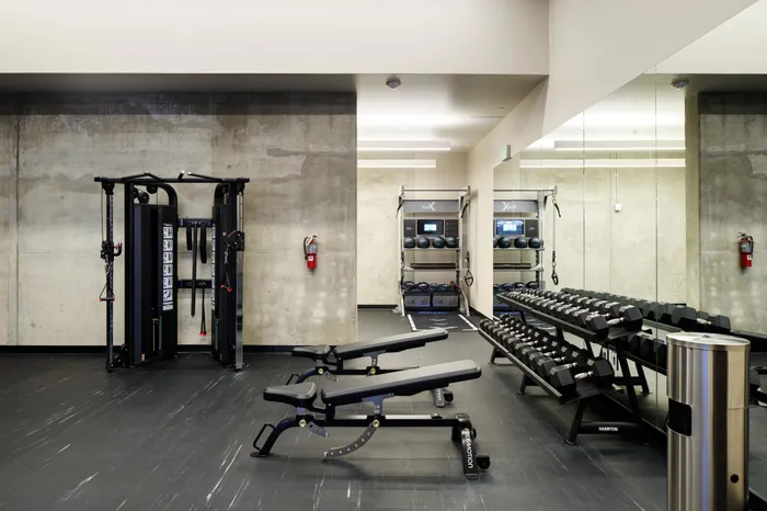large fitness center with high-end equipment at Modera Berkeley apartments California