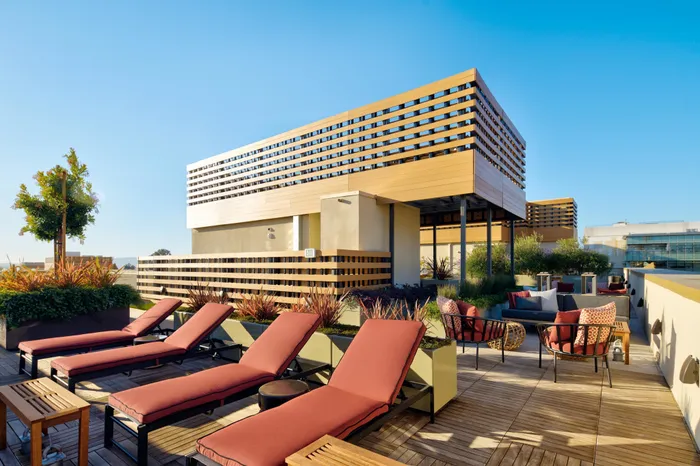 sunbathing lounge chairs on rooftop at Modera Berkeley apartments California