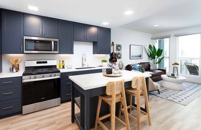 Kitchen at Modera San Diego looking into living room with private balcony to the right
