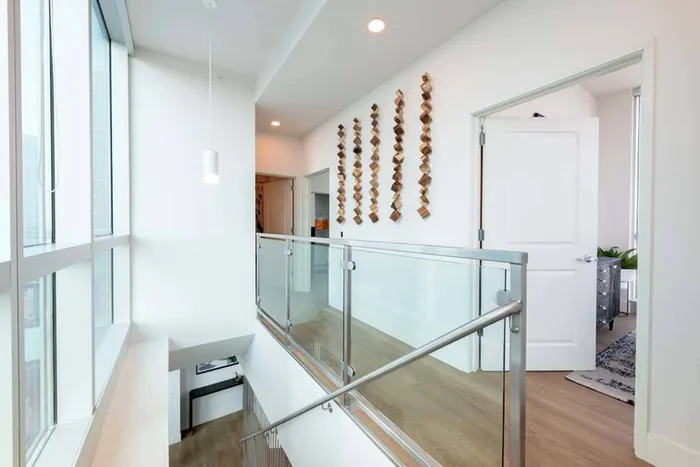 Loft and upstairs hallway opening to bedroom area at Modera Rincon Hill apartments.