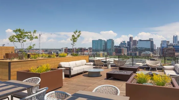 Rooftop with firepits, seating, and views of downtown Denver