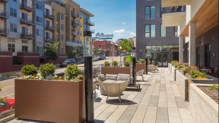 Outdoor patio just above street level offers seating nooks and lots of sunshine