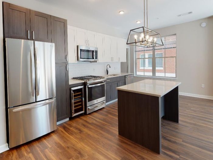 VERSO kitchen with upgraded features like a pendant lantern over large kitchen island and wine fridge