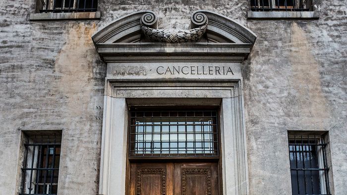 Exterior of original stone architectural features above a wooden door
