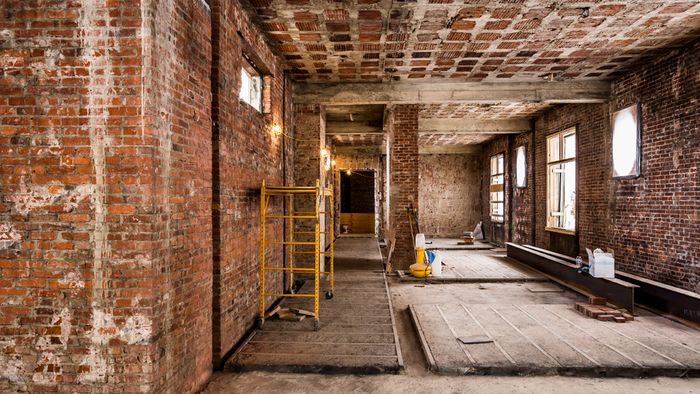 Galley room with exposed brick during renovations