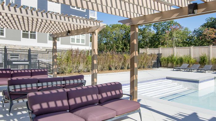 Salt Water Pool and Sun Deck with Covered Seating Options at Modera Needham Apartments