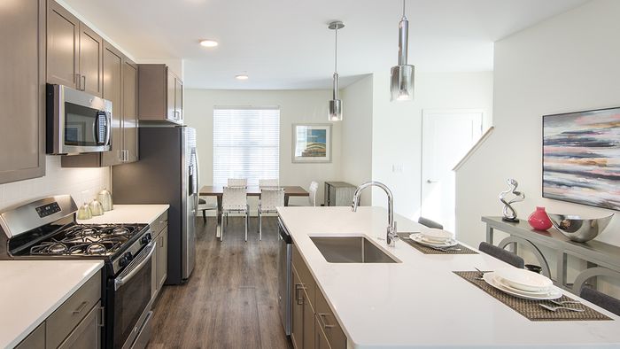 Modera Needham apartment kitchens feature wood plank-style flooring in beautiful apartments.