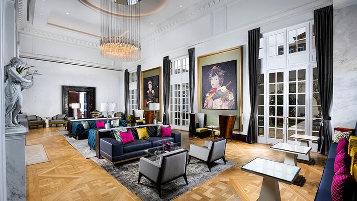 A grand ballroom with preserved crown molding and parquet floors