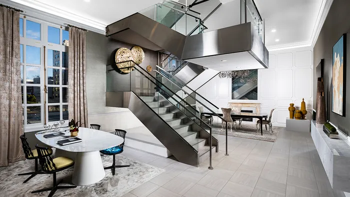 A touch of modern with a steel and glass staircase amidst the leasing area