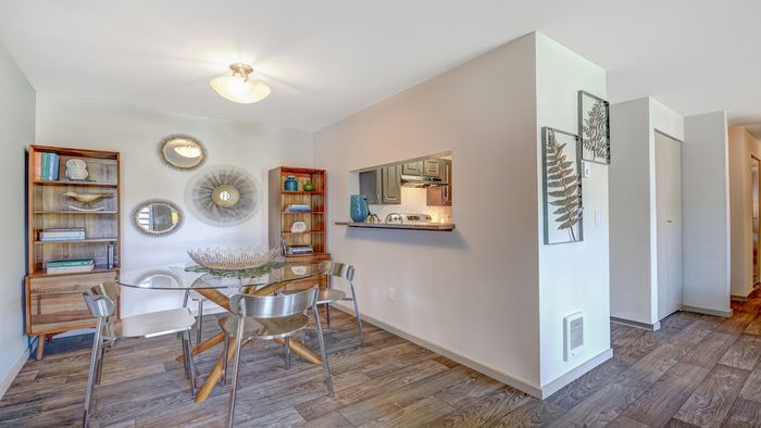 Kitchen with Breakfast Bar featuring faux wood plank flooring