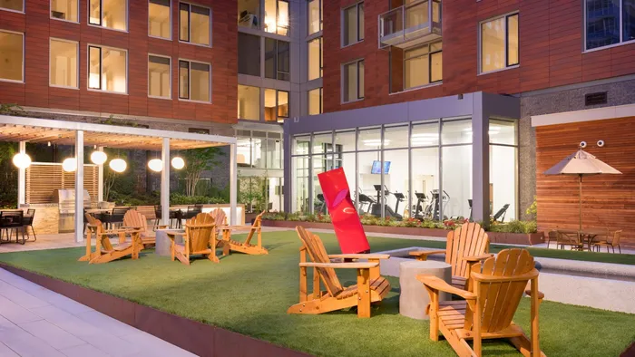 Outdoor courtyard with turf grass and various seating options