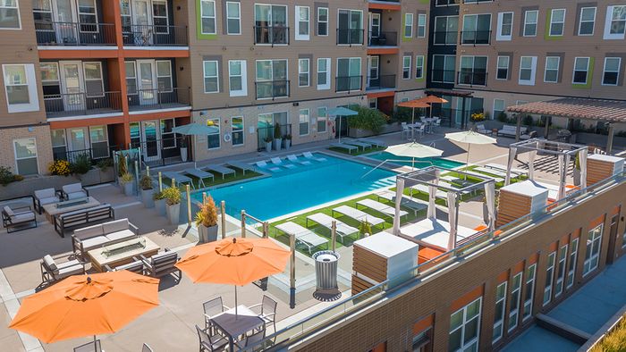 Resort-style outdoor lounge area, swimming pool, and grilling stations