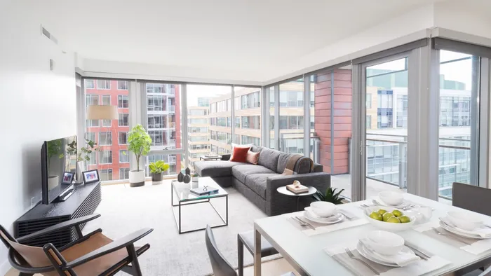 Living room with wall of floor to ceiling windows in the background