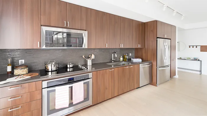 Kitchen with stainless steel appliances and dark quartz counter tops