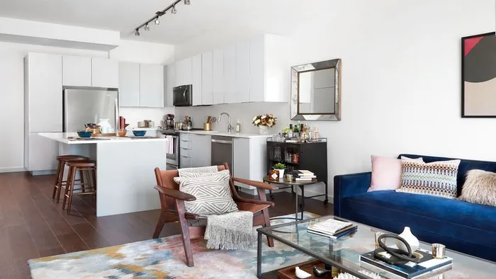 L Shaped Kitchen with White Cabinetry, Stainless Steel Appliances, and Island