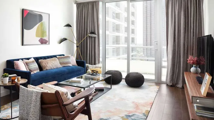 Living room with floor to ceiling sliding glass doors to private balcony
