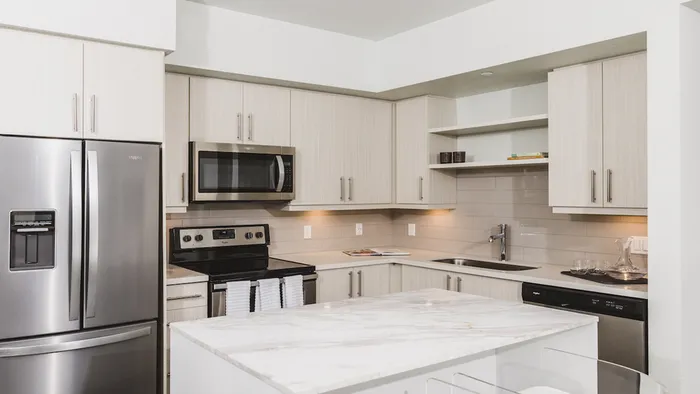 Stunning kitchens with french door stainless steel refrigerators, quartz counters, tile backsplash, and built in shelving