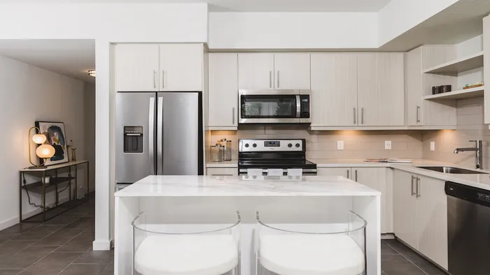 Kitchens with custom cabinetry, bar seating, and built-in shelves.