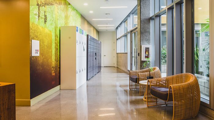 Mail room with floor to ceiling windows and package lockers