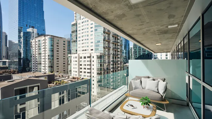 Private balcony with stunning city views and private seating area at Modera Rincon Hill apartments.