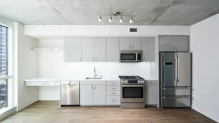 Light and airy sleek grey lacquer cabinets in an apartment at Modera Rincon Hill.