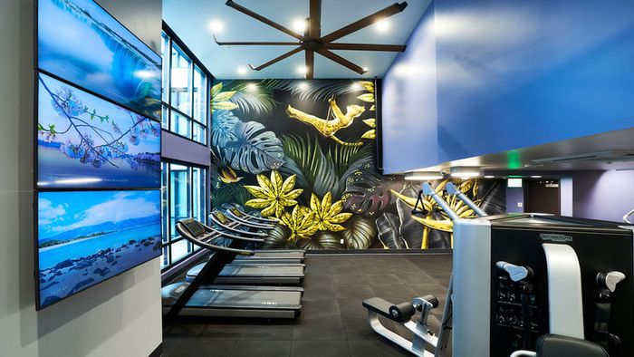 HIIT inspired fitness center with gorgeous art mural at Modera Rincon Hill apartments.