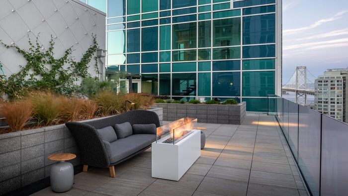 Take in the San Francisco Bay Bridge with firepits and cozy lounge spaces at Modera Rincon Hill apartments.