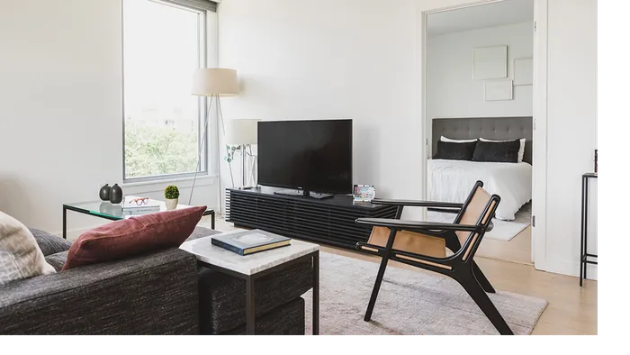 Interior living room with sofa, tv, chair and oversized window