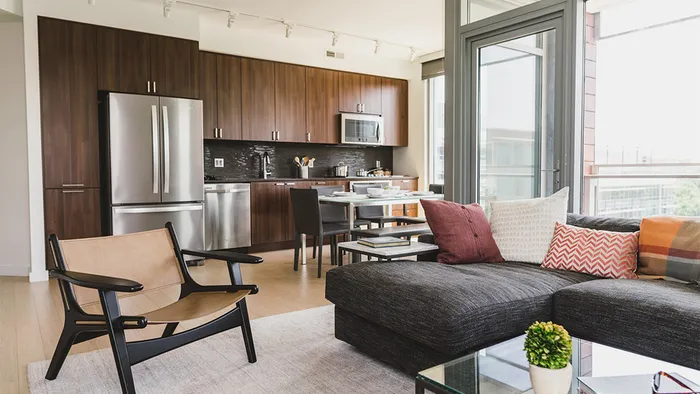 Kitchen and living room with sofa and oversized windows