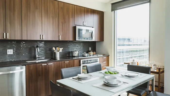 Kitchen table with cabinets in background and oversized window