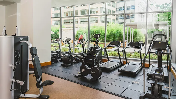 Cardio machines in fitness center overlooking courtyard