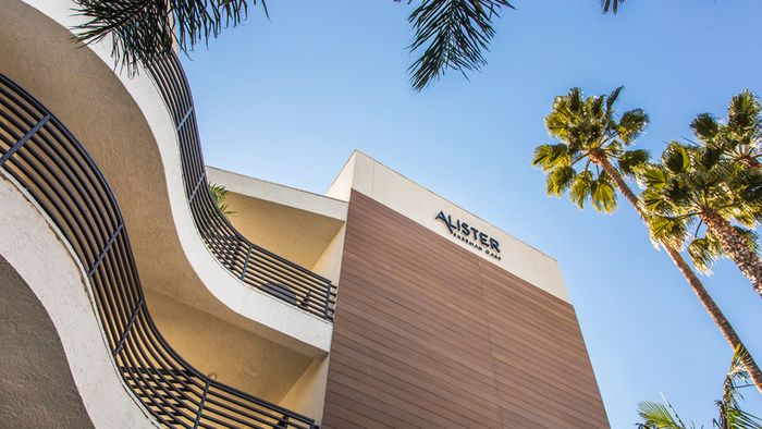 Community exterior looking up to name on building.