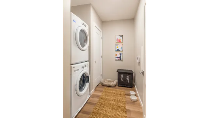 View of hallway featuring a Full-size front loading washers and dryers