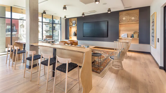 WiFi Lounge with a Large Flatscreen TV, Natural-Edged Wooden Bar, Leather-style seating and Modern Decor