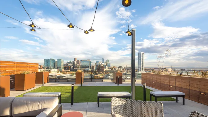 Rooftop Deck Lounge Area with Green Spaces and Panoramic Views of the City