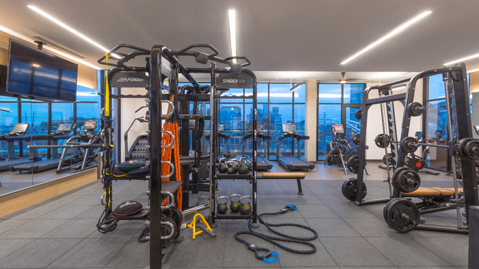 HIIT inspired fitness center featuring TRX equipment, Club-quality weight machines, and City Views