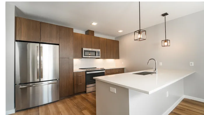 Open concept kitchens with large espresso cabinetry and stainless steel appliances