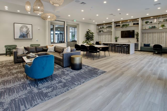 Plenty of gathering space and seating in the clubroom at modera berkeley heights apartments in new jersey