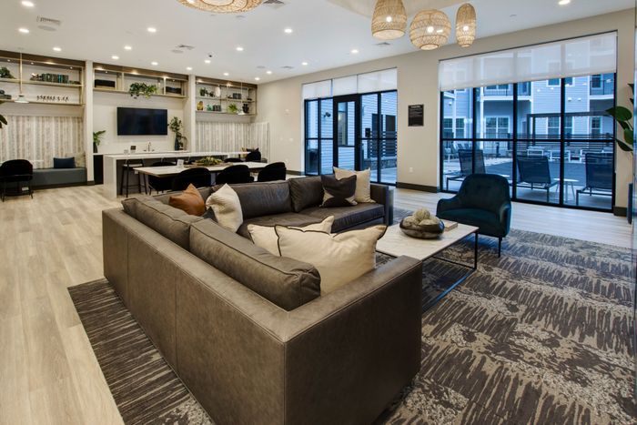 seating area looking out onto pool at modera berkeley heights apartments in new jersey