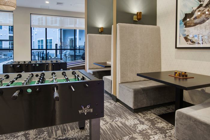 foosball table in entertainment space at modera berkeley heights apartments in new jersey