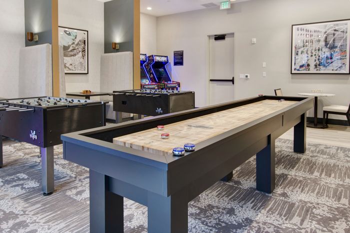 arcade games and shuffleboard at modera berkeley heights apartments in new jersey