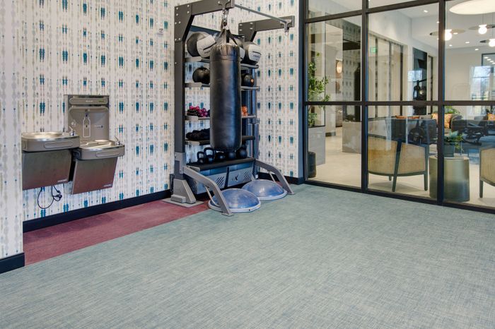 Club-quality fitness studio with group fitness area at modera berkeley heights apartments in new jersey
