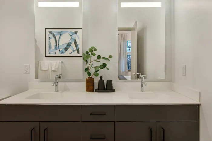 Double vanities and linen storage space* at modera berkeley heights apartments in new jersey